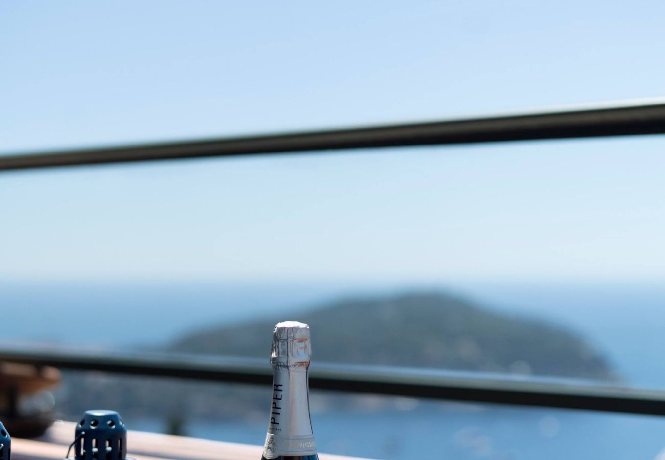 Coffee table on the terrace with a bottle of champagne and champagne flutes